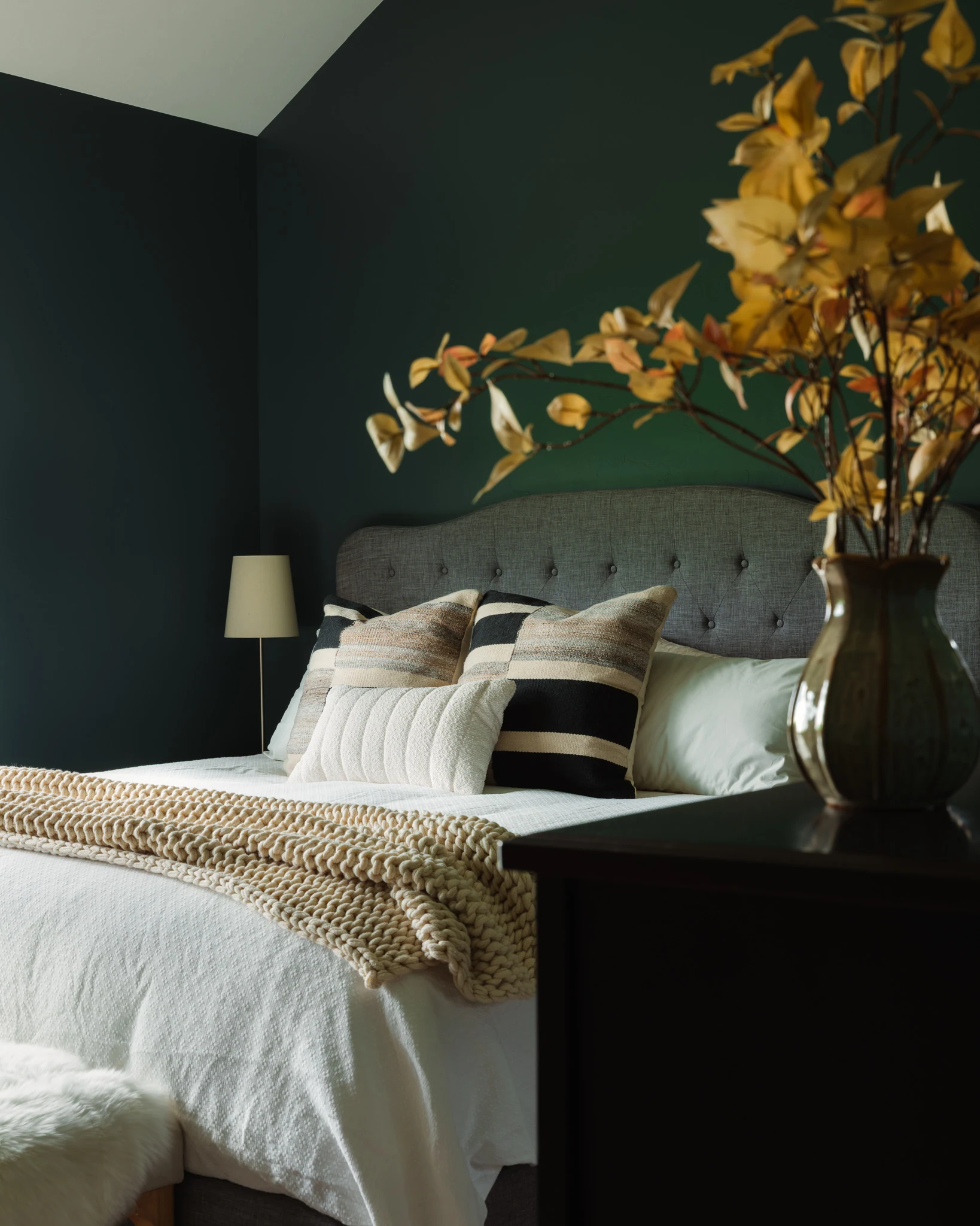 Bedroom detail with a tufted headboard and styled pillows — interior design photography Livingston Montana, Sam Schlauch Designs